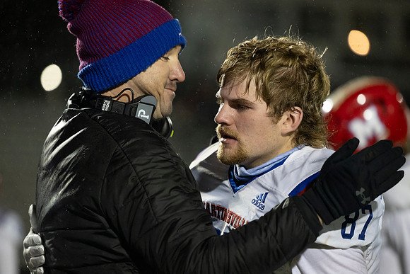 Emotions Coach Dugger and senior Josh Jones after Semi State