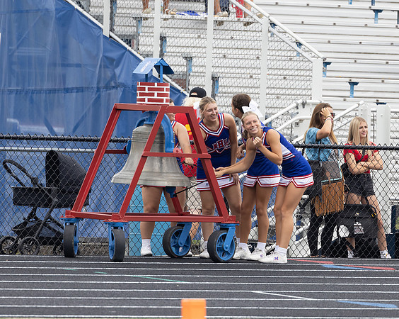 Cheerleaders Ringing the bell after a touchdown.